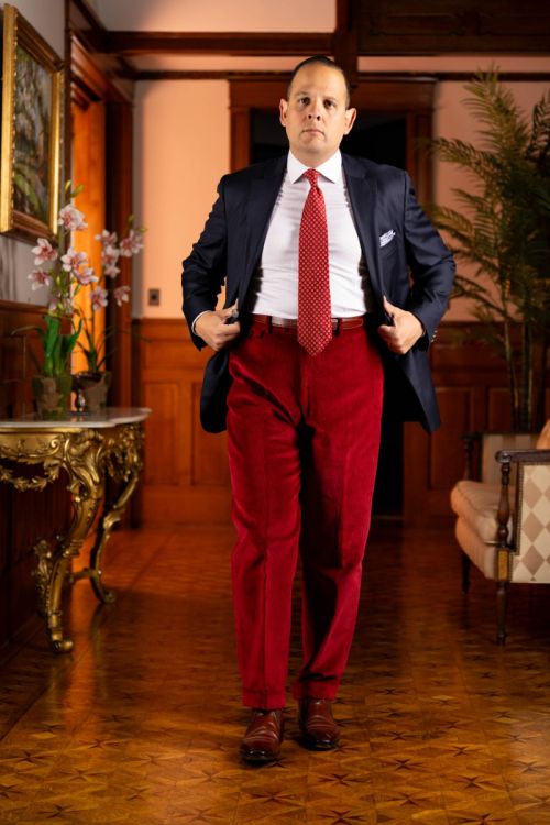 Raphael wearing a blue jacket paired with the garnet red corduroy trousers.