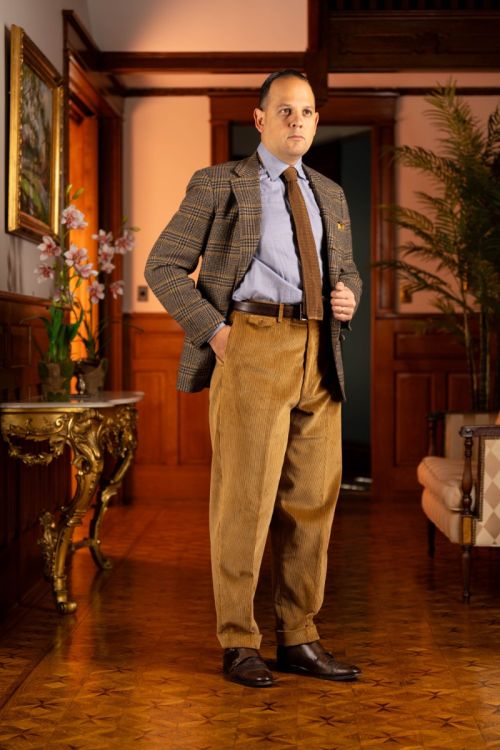 Raphael sporting the Camel corduroy trousers with his left hand tucket inside the trouser pocket. 