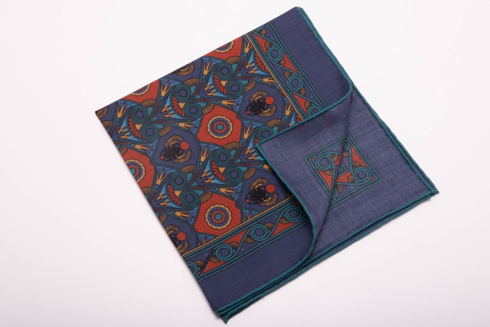 Back of Sapphire Blue Pocket Square Art Deco Egyptian Scarab pattern in burnt orange, yellow, madder blue with teal contrast edge by Fort Belvedere 