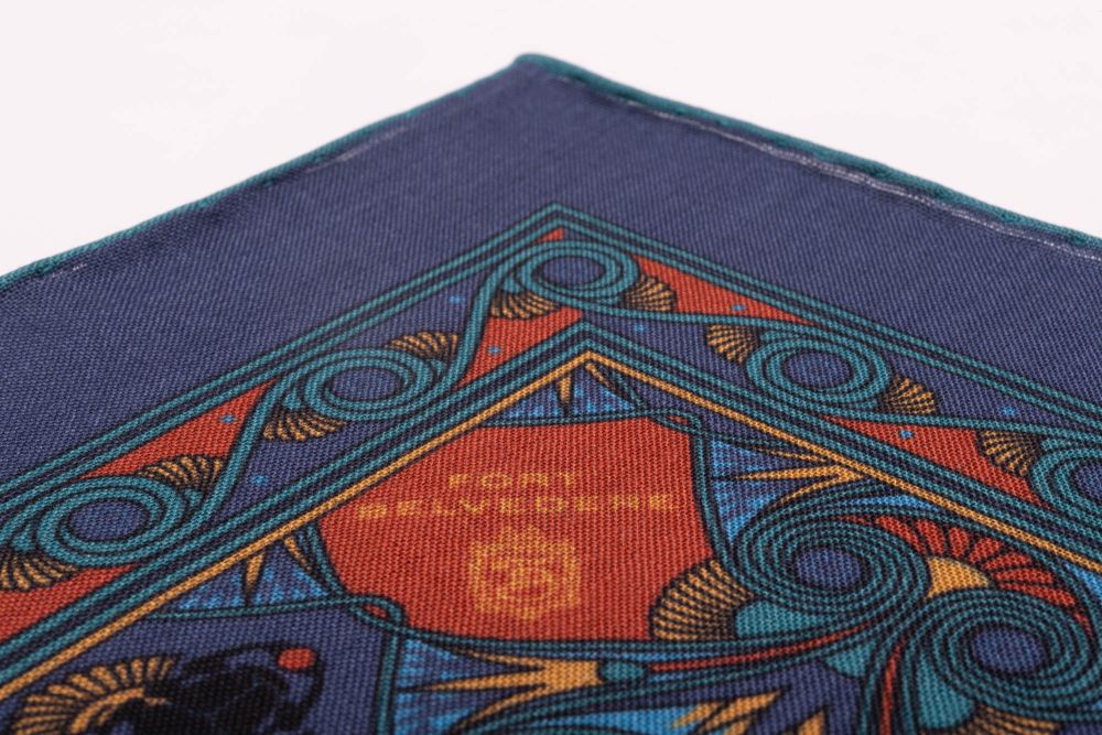 Edge of Sapphire Blue Pocket Square Art Deco Egyptian Scarab pattern in burnt orange, yellow, madder blue with teal contrast edge by Fort Belvedere 