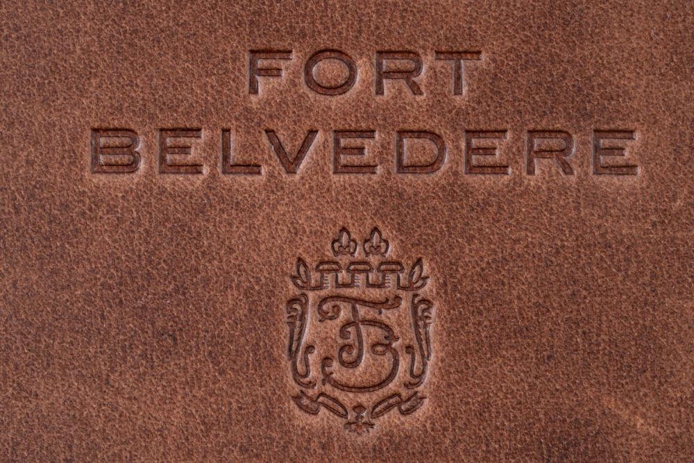 Color depth of the Montecristo leather in saddle brown with embossed Fort Belvedere logo on slim wallet