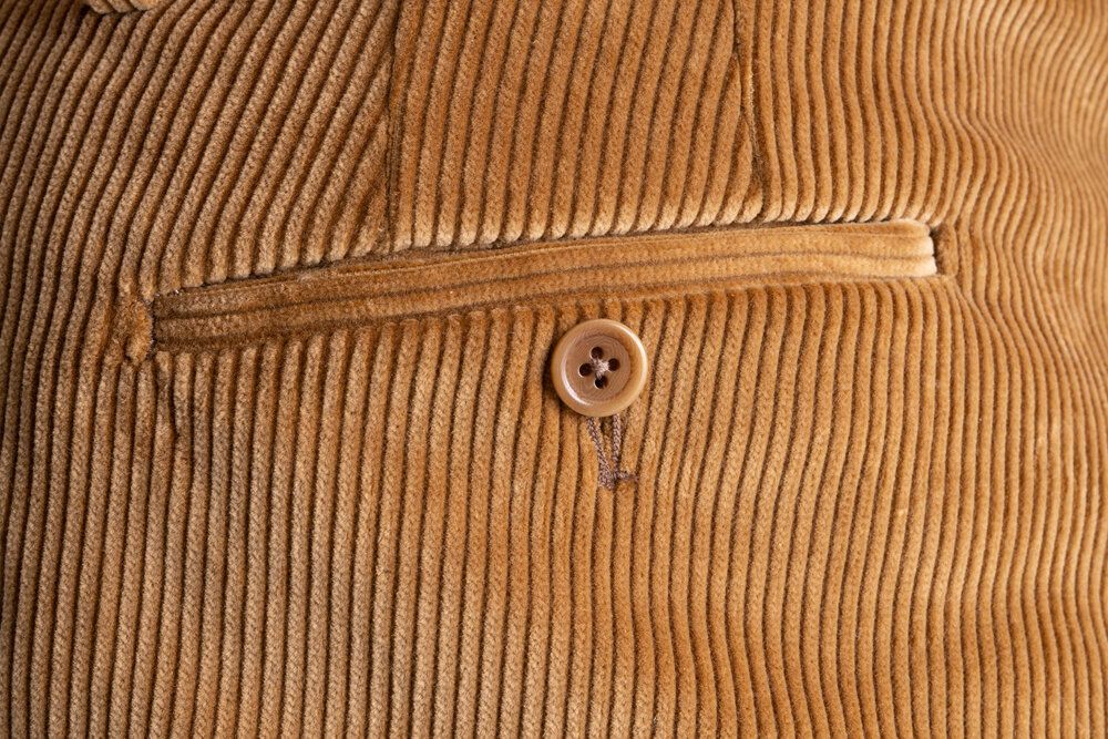 Close up view of the back pocket of the Camel Corduroy trousers. 
