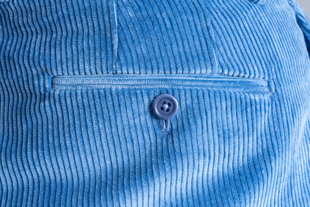Back pocket darts and jetted pocket with button closure featuring a color matching genuine corozo button on a pair of Fort Belvedere Stancliffe pants.