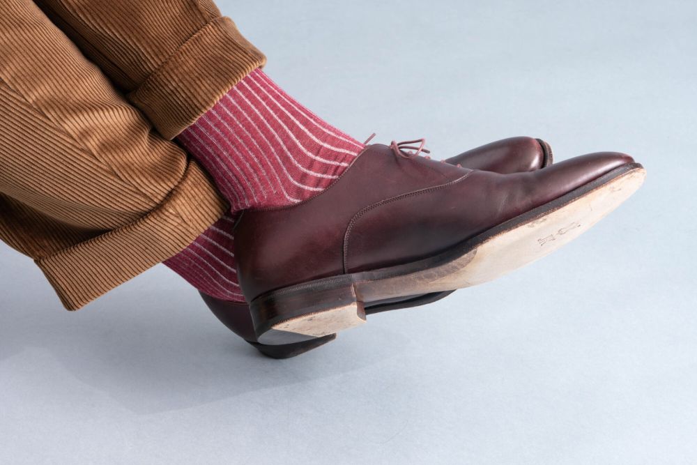 Cognac Stancliffe Corduroy Trousers by Fort Belvedere paired with burgundy and off-white shadow striped socks by the same brand as well as burgundy oxfords with a JR sole.