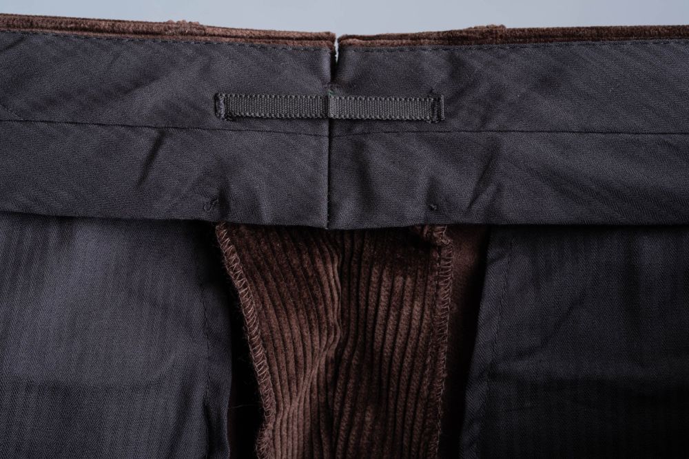 Dark Brown Stancliffe Corduroy Pants with 3 inches or 7.5 cm fabric reserve in the waist and a practical look on the inside to hang the pants.