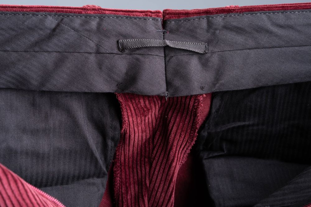 Maroon Stancliffe Corduroy Pants with 3 inches or 7.5 cm fabric reserve in the waist and a practical look on the inside to hang the pants.