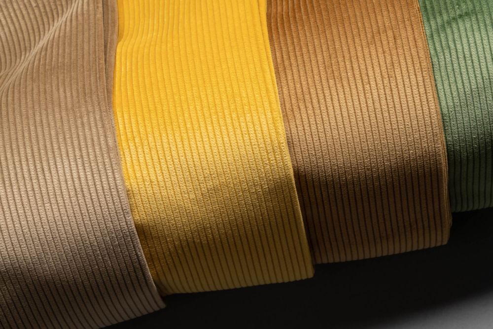 Goldenrod colored Luxuroy Corduroy fabric by Fort Belvedere. The fabric looks different depending on how the light falls on it. It has a beautiful lustre not found in generic corduroy fabrics.
