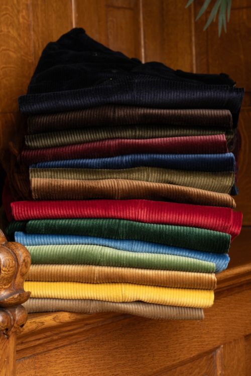 Casually stacked Fort Belvedere Corduroy pants in multiple colors, including the Midnight Blue one 