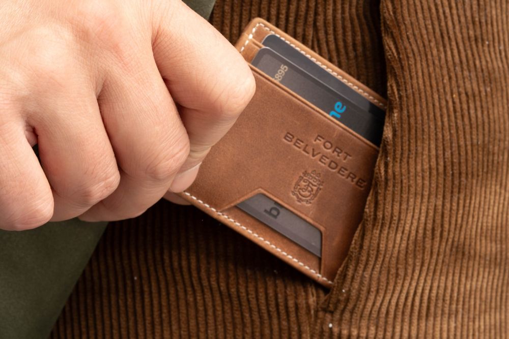 Four Card Carrier Slim Wallet in Saddle Brown Montecristo Leather is embossed with the Fort Belvedere branding. 