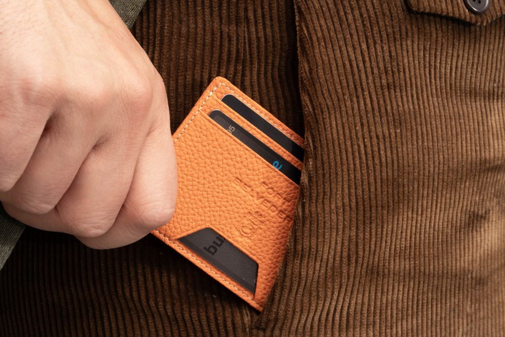 The Orange Togo Full-Grain Leather 4CC Wallet is embossed with the Fort Belvedere