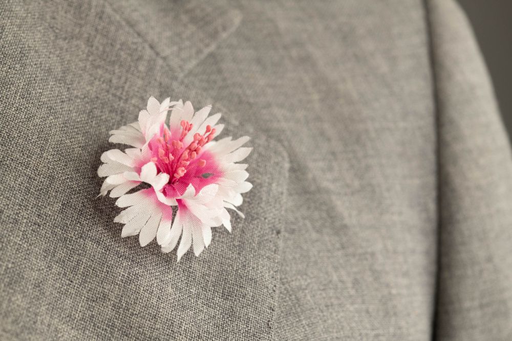 White and Magenta Cornflower Boutonniere in Gray suit