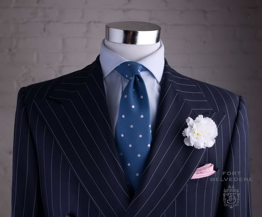 White Life Size Carnation on Chalk Stripe suit with light pink linen pocket square & Blue Jacquard Silk Polka Dot tie by Fort Belvedere