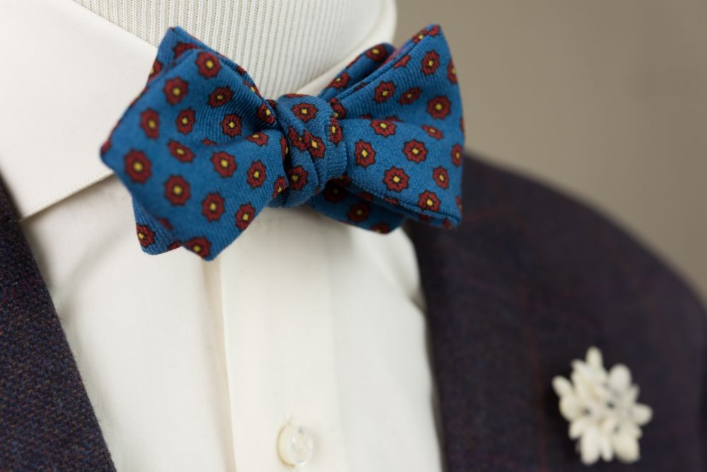 Wool Challis Bow Tie in Mohair Blue with Red & Yellow Pattern paired with Edelweiss Boutonniere - Handmade by Fort Belvedere
