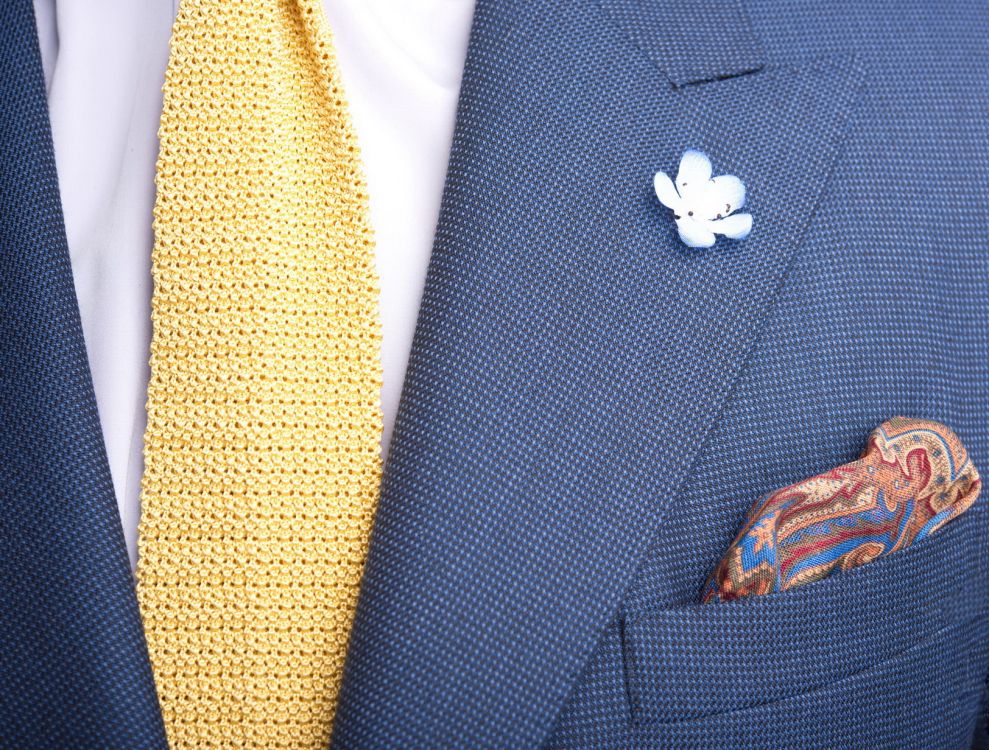 Yellow knit tie with pocket square and light blue boutonniere