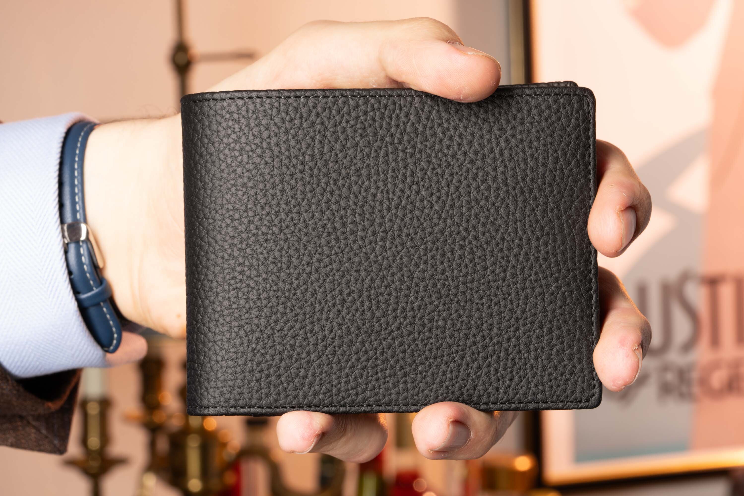 Holding Eight Card Carrier Bifold Wallet in Black Togo Leather