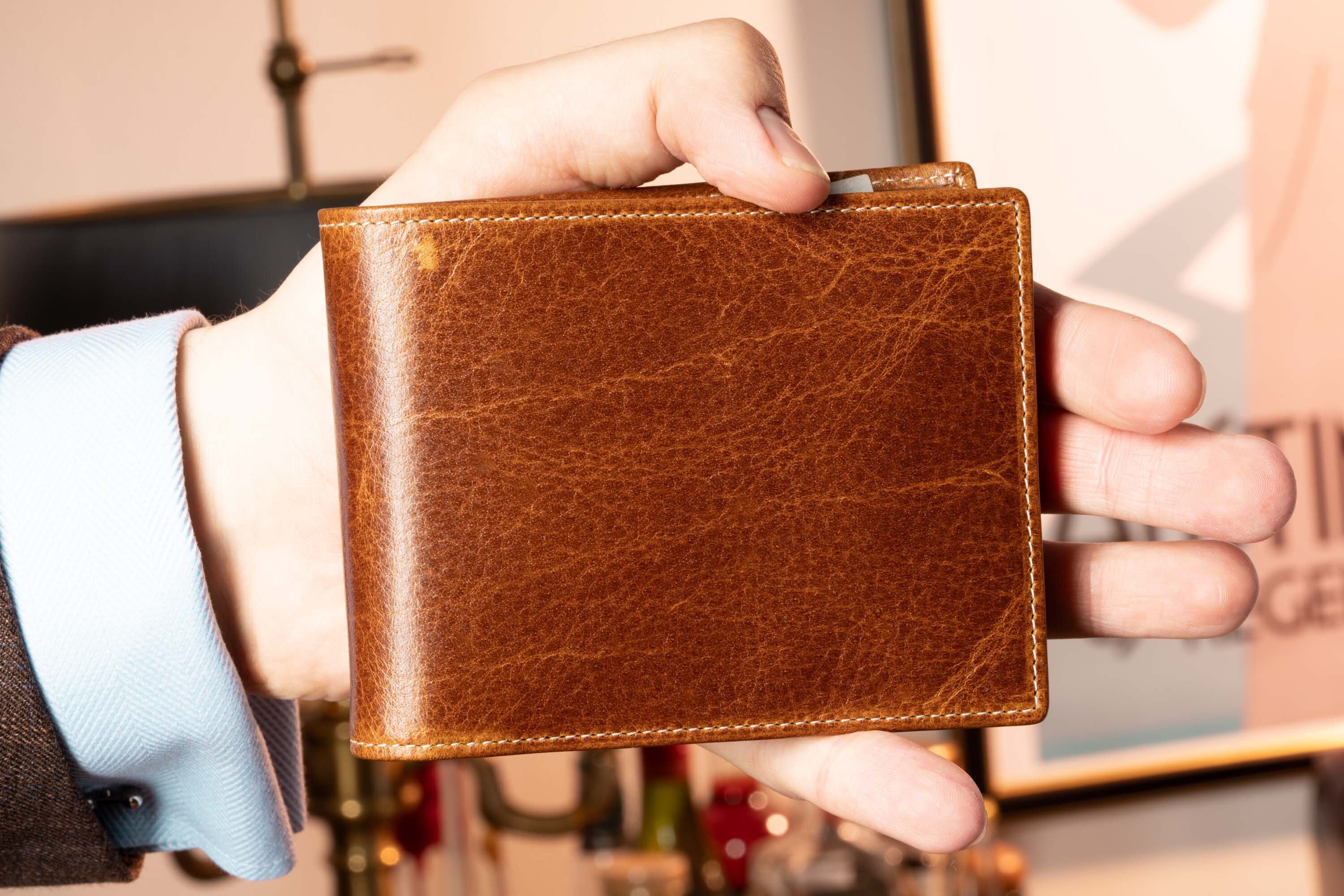 Holding Saddle Brown Bifold Wallet in Full-Grain Dumont Leather