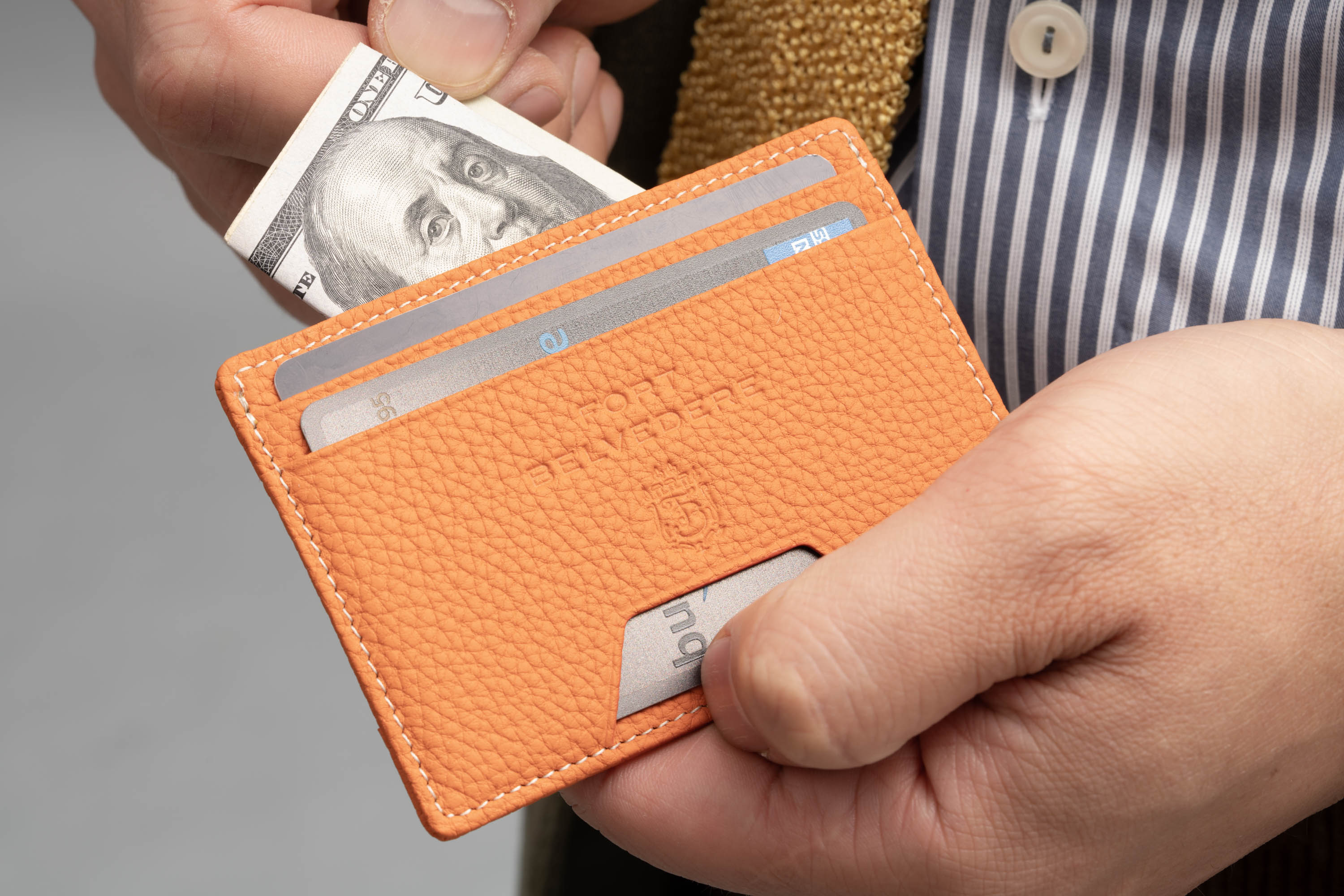 Orange Togo  Full-Grain Leather 4CC Wallet can hold bills and cards.