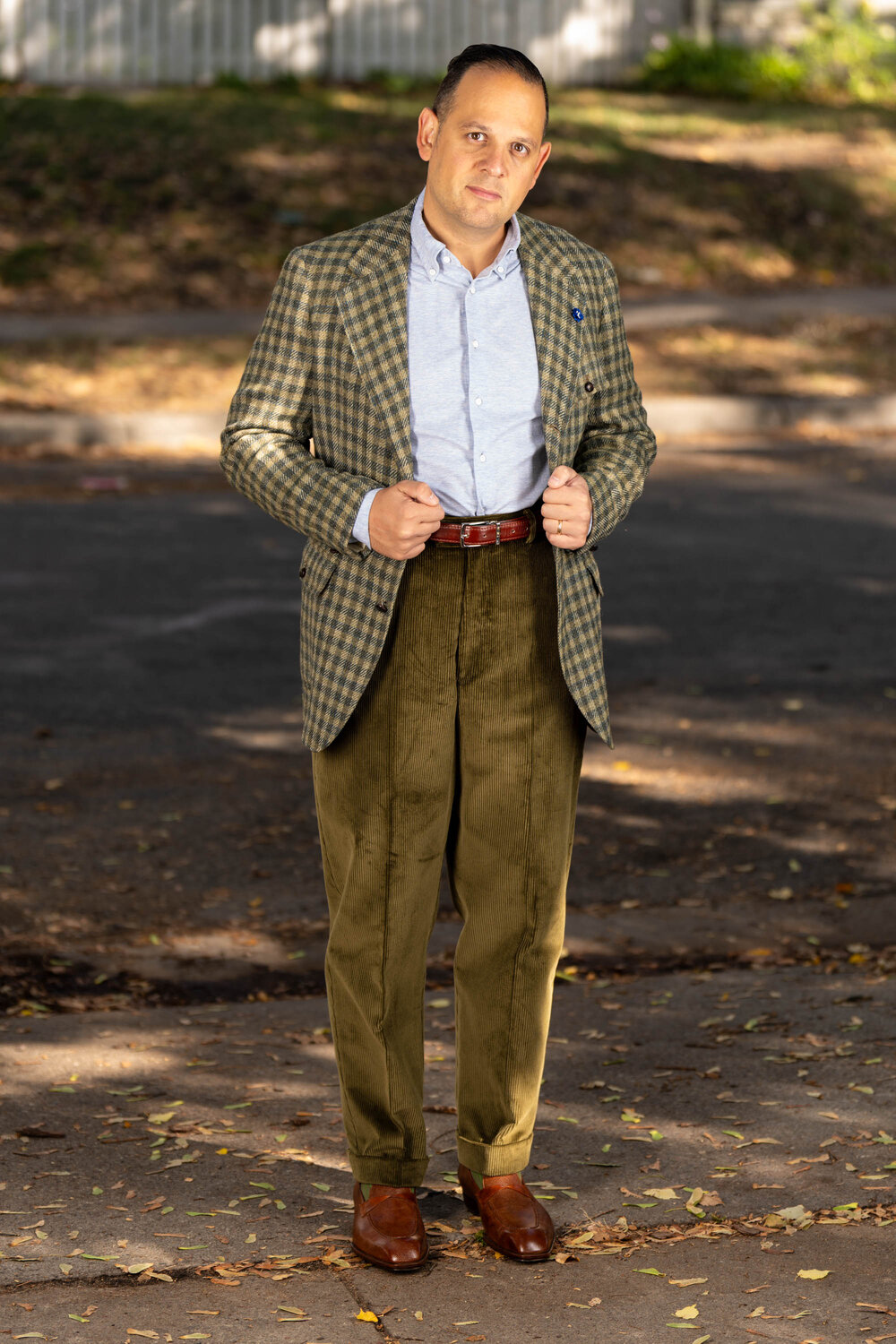 Raphael wearing a checked jacket paired with the khaki drab corduroy trousers.
