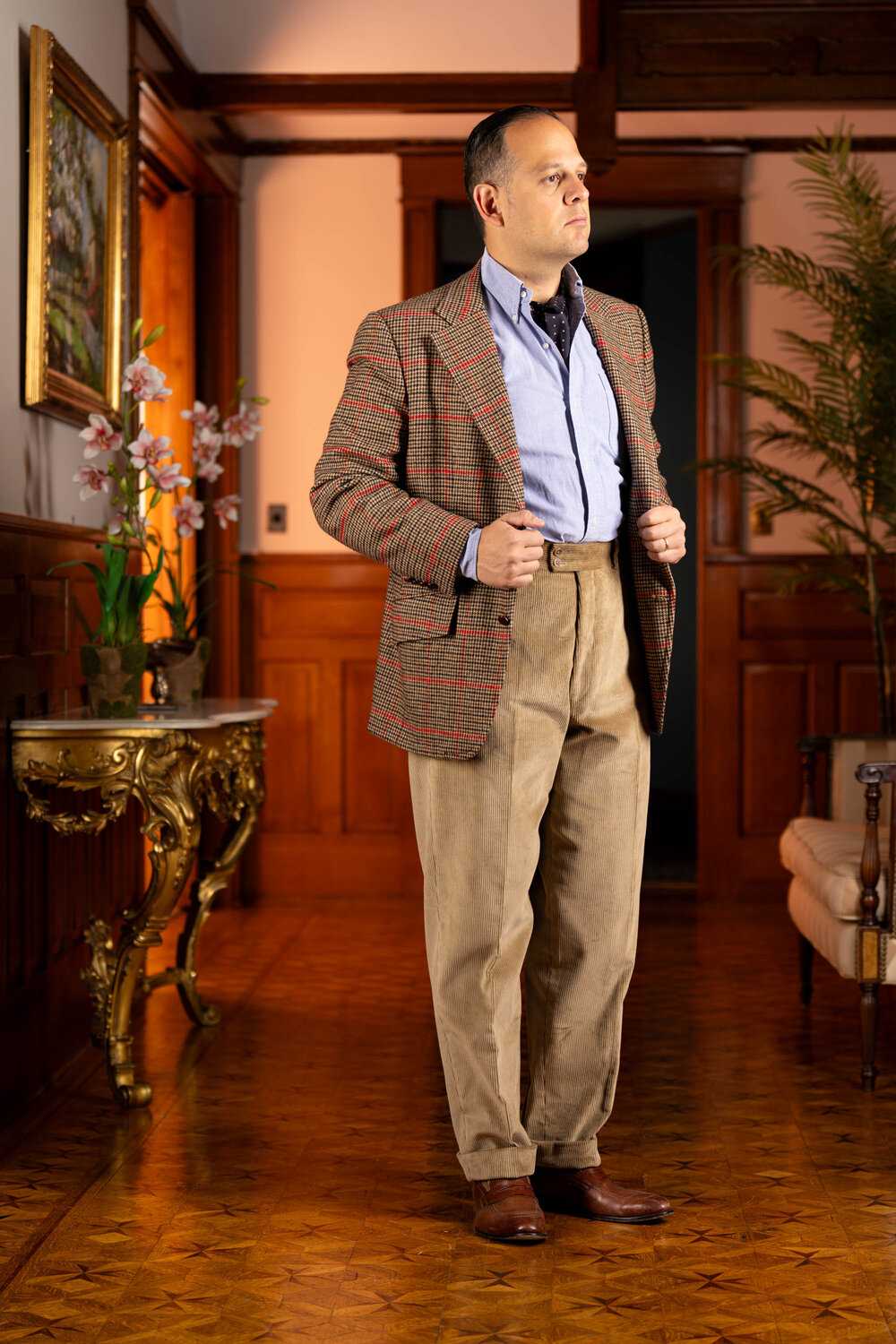 Raphael wearing the pale taupe corduroy pants inside with a sport coat