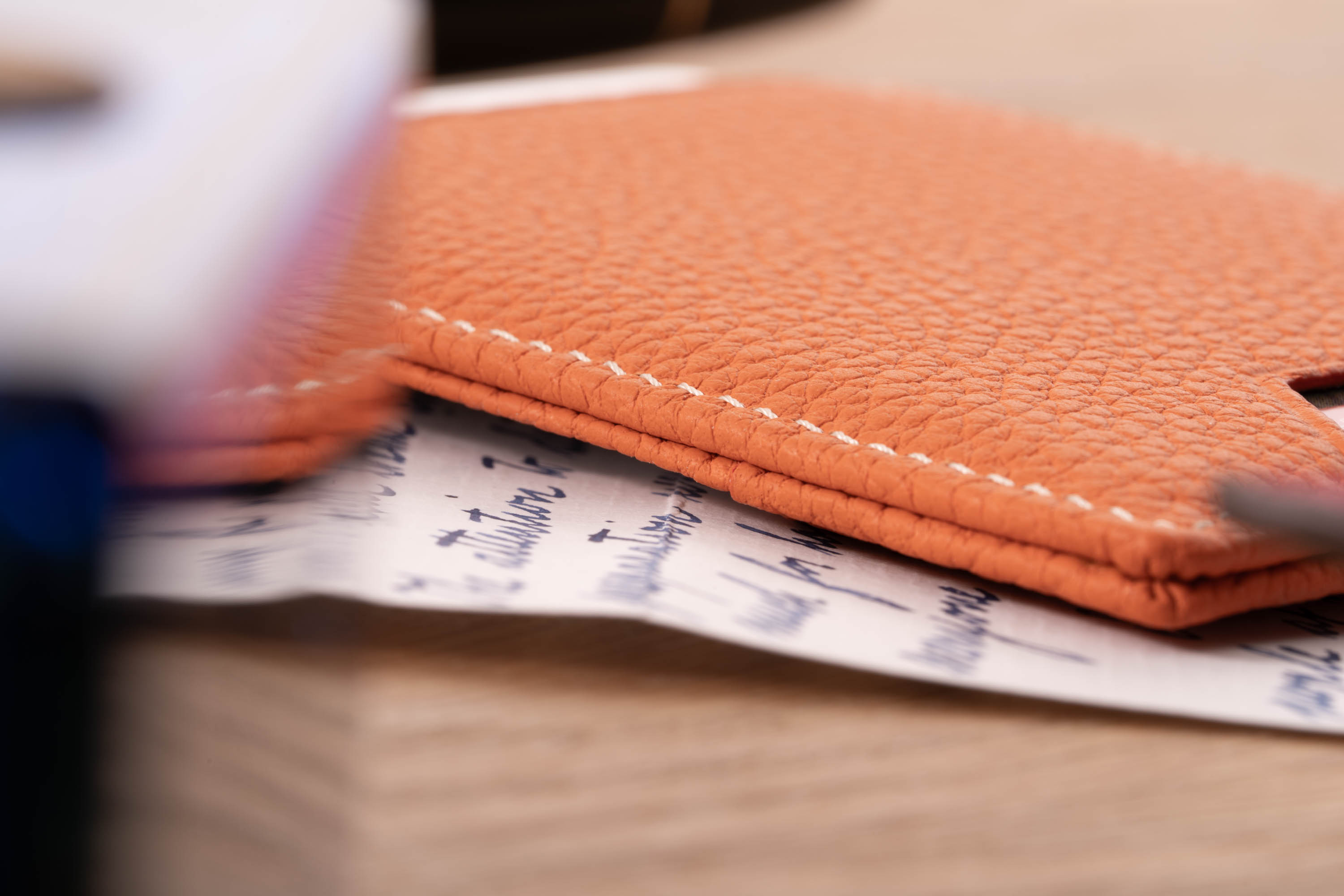 Neatly folded edges on an Orange Togo Full-Grain Leather 4CC Wallet by Fort Belvedere