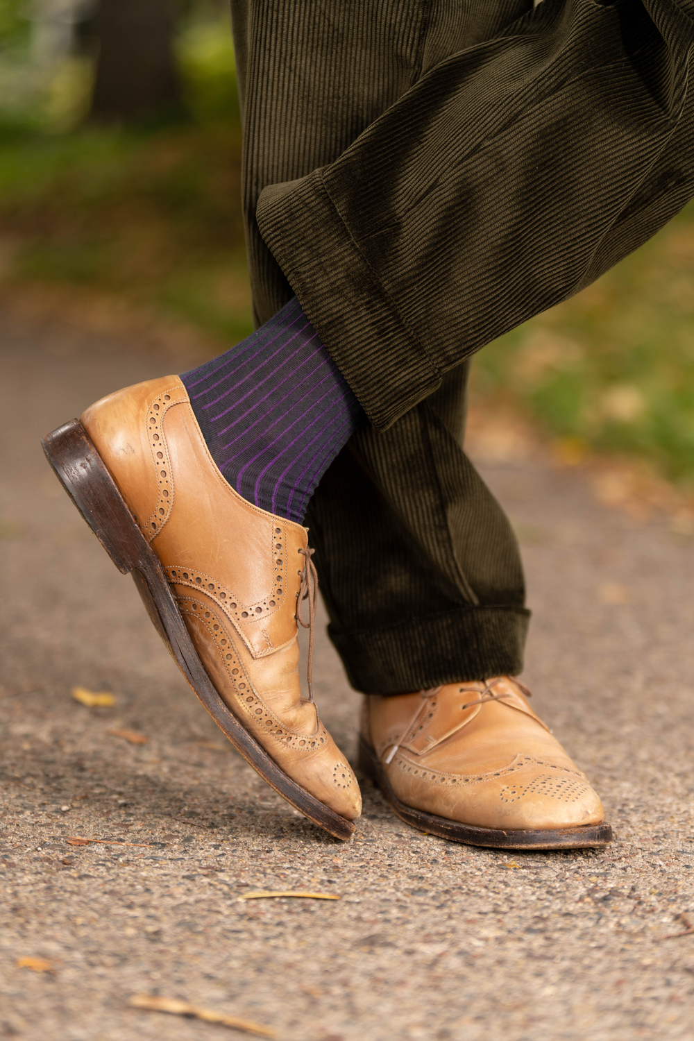 Dark Olive Corduroy trousers with cuffs paired with Cognac tan brogue oxfords  and Dark Green and Purple Shadow Stripe Ribbed Socks.