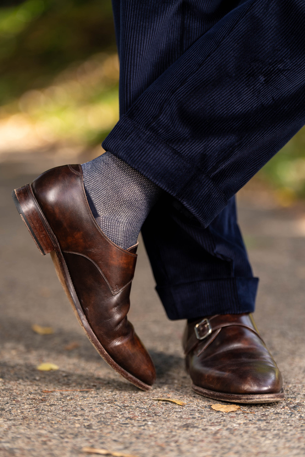 Midnight Blue Corduroy trousers with cuffs paired with brown monk straps and Two-Tone Solid Socks.
