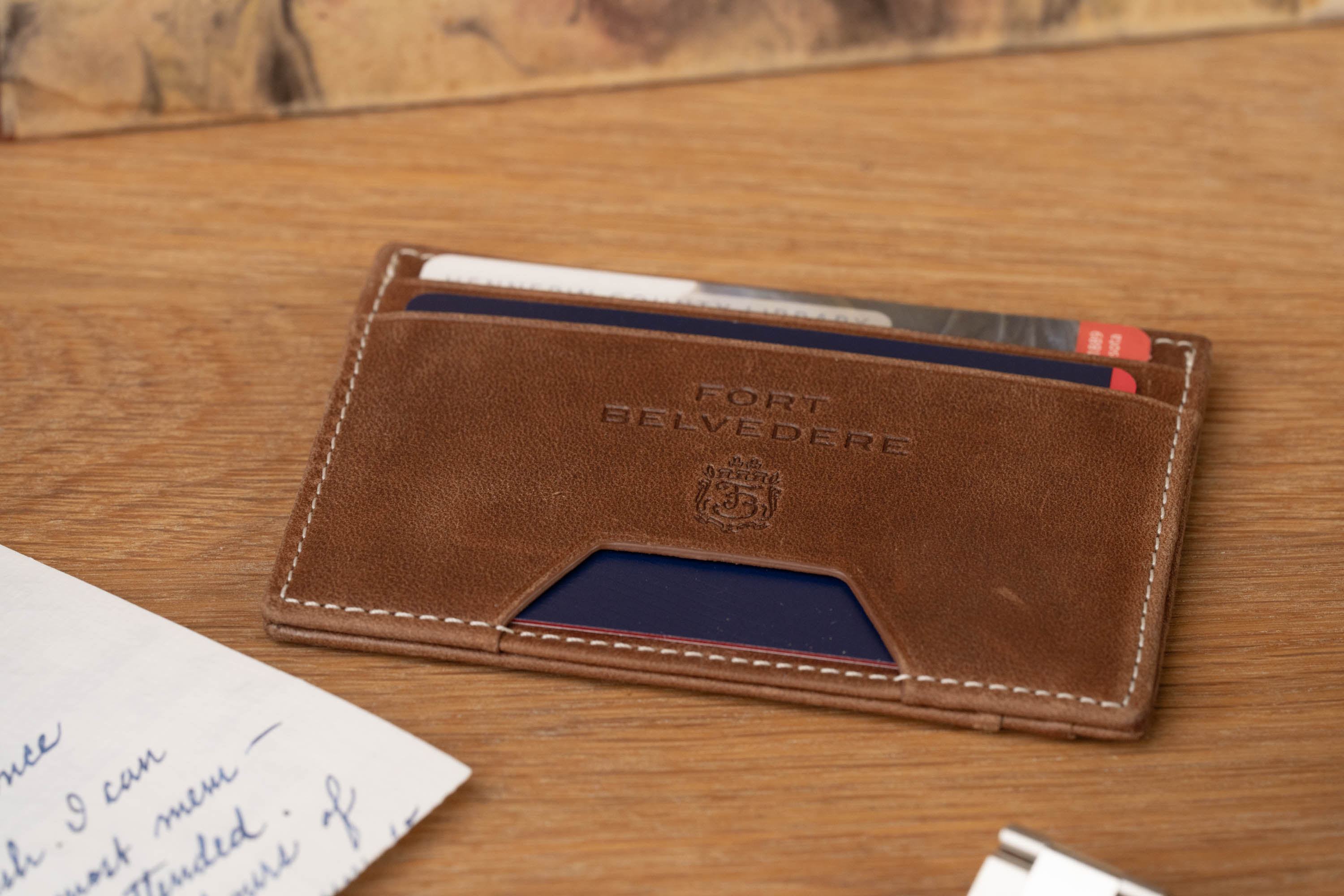 Four Card Carrier Slim Wallet in Saddle Brown Montecristo Leather has warm dye. 